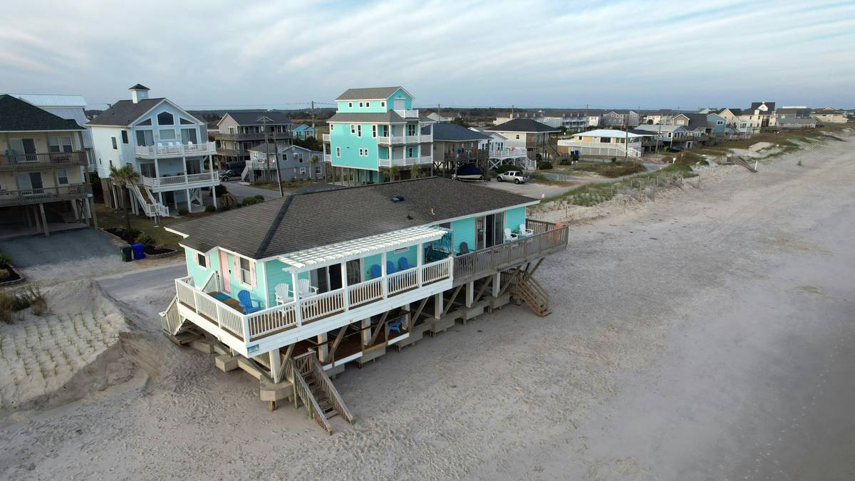 a group of houses on a beach