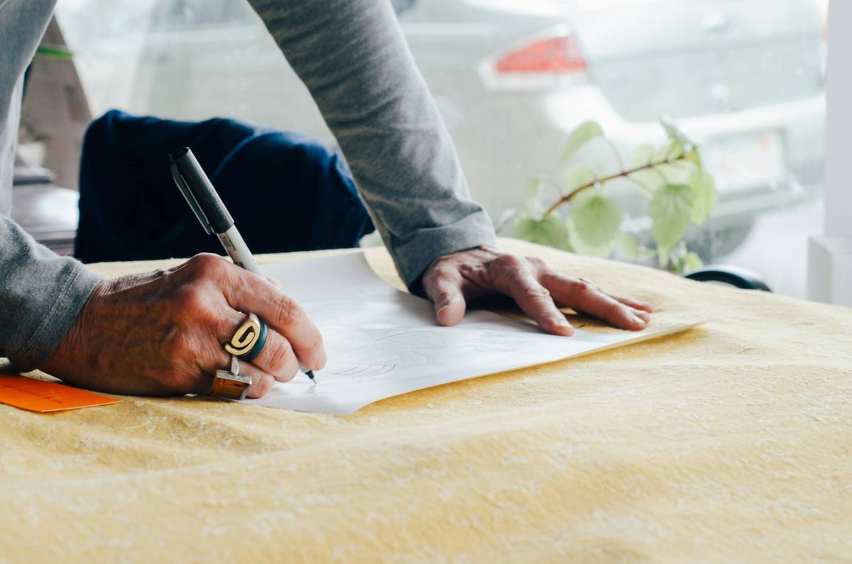 Designer leaning over table