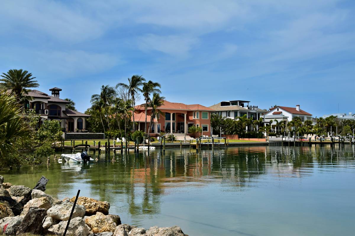 Infographic showing key Sarasota FL vacation rental regulations including permit requirements, zoning rules, and tax obligations